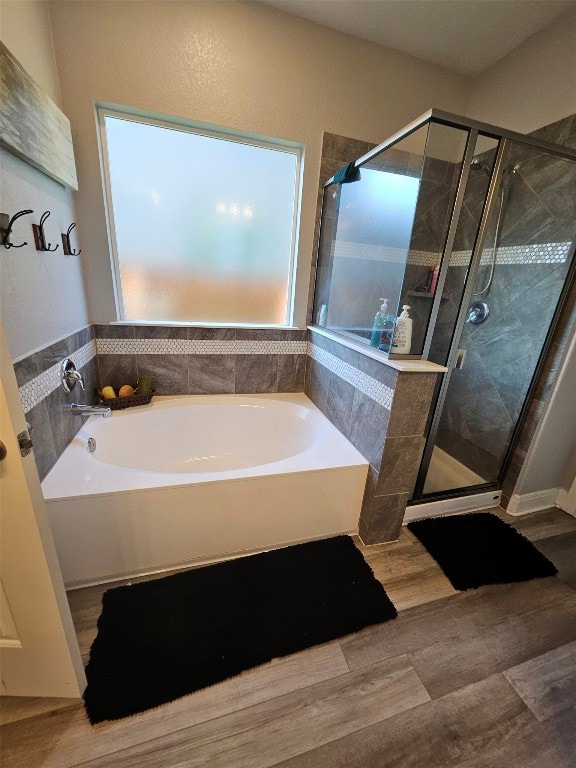 bathroom with separate shower and tub and wood-type flooring