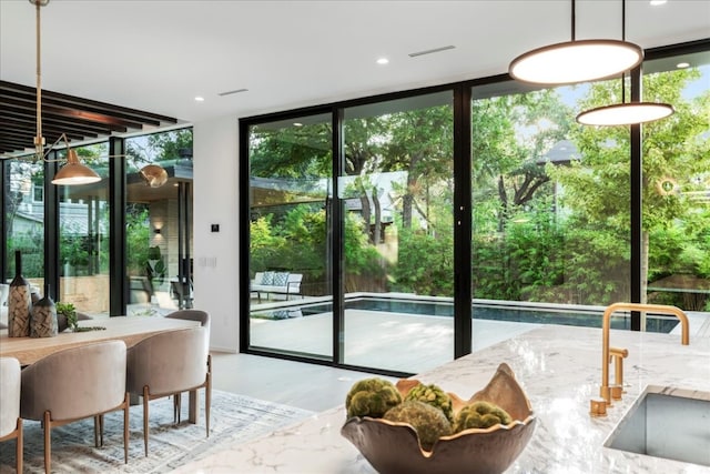 entryway with a wall of windows and sink