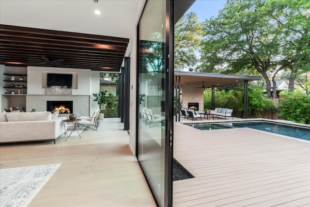 exterior space featuring a wealth of natural light, a fireplace, and light hardwood / wood-style floors