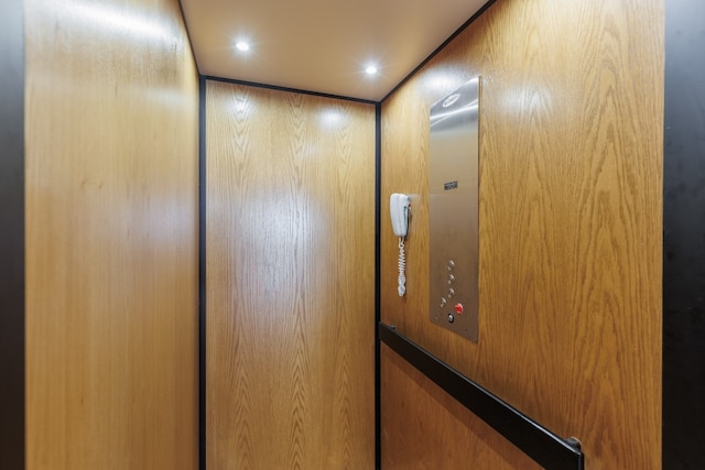 interior details featuring elevator and wooden walls