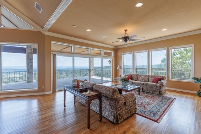 living room featuring ceiling fan, wood-type flooring, and ornamental molding