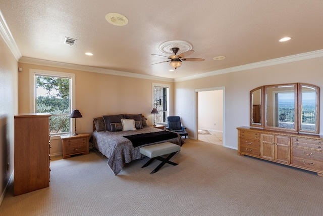 carpeted bedroom featuring ceiling fan, ornamental molding, and a textured ceiling