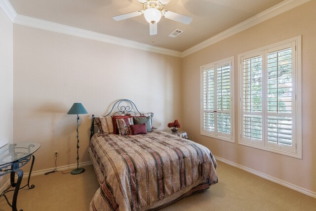 carpeted bedroom with ceiling fan and crown molding