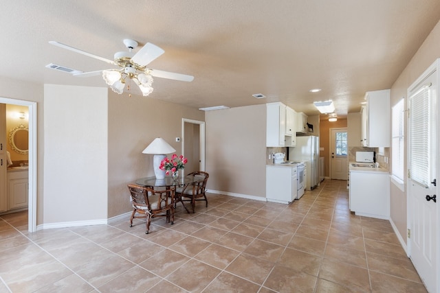 kitchen with ceiling fan, white cabinetry, electric stove, and light tile patterned floors