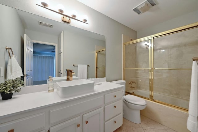 full bathroom featuring combined bath / shower with glass door, vanity, toilet, and tile patterned flooring