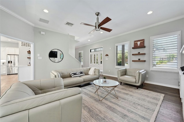 living room with wood-type flooring, crown molding, and ceiling fan