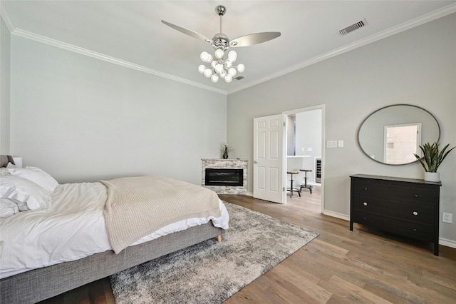 bedroom featuring ceiling fan, hardwood / wood-style flooring, and ornamental molding