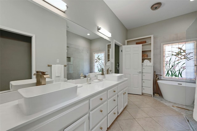 bathroom with shower with separate bathtub, vanity, and tile patterned floors