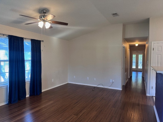 unfurnished room featuring lofted ceiling, dark hardwood / wood-style floors, and ceiling fan