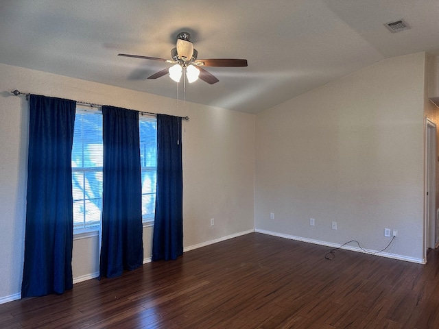 unfurnished room with ceiling fan, vaulted ceiling, and dark wood-type flooring