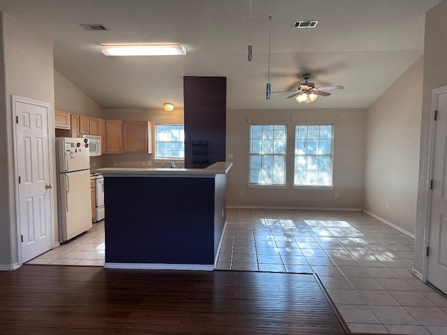 kitchen with ceiling fan, light brown cabinets, light wood-type flooring, and white appliances