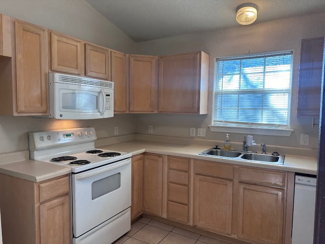 kitchen featuring light brown cabinetry, sink, and white appliances