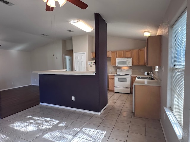 kitchen featuring ceiling fan, light tile patterned floors, sink, white appliances, and vaulted ceiling