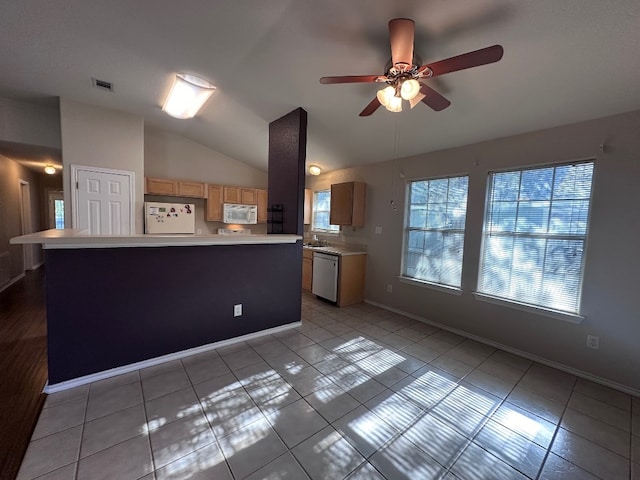 kitchen with light tile patterned flooring, white appliances, a kitchen island, lofted ceiling, and ceiling fan