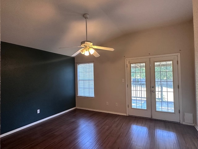 unfurnished room with lofted ceiling, dark wood-type flooring, ceiling fan, and french doors