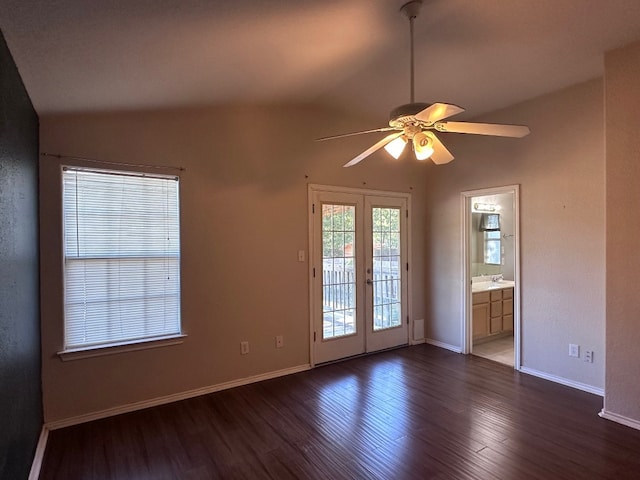 spare room featuring ceiling fan, lofted ceiling, dark hardwood / wood-style floors, and french doors