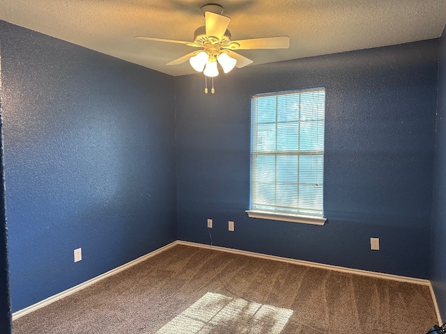 carpeted empty room featuring ceiling fan and a textured ceiling