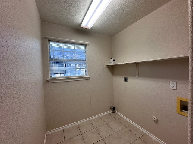 laundry room featuring washer hookup, a textured ceiling, electric dryer hookup, light tile patterned floors, and gas dryer hookup