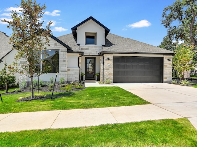 view of front of house featuring a front lawn and a garage