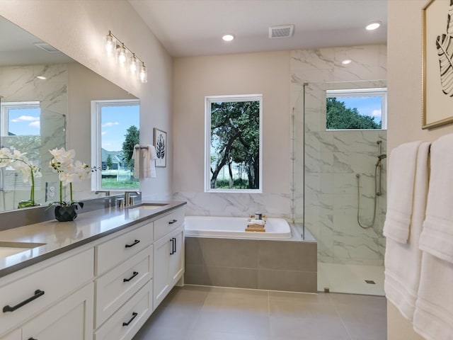 bathroom with separate shower and tub, plenty of natural light, and tile patterned flooring