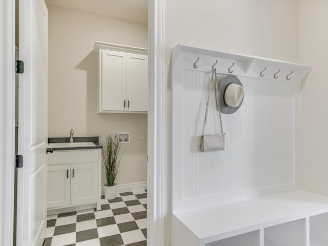 mudroom with light tile patterned flooring and sink