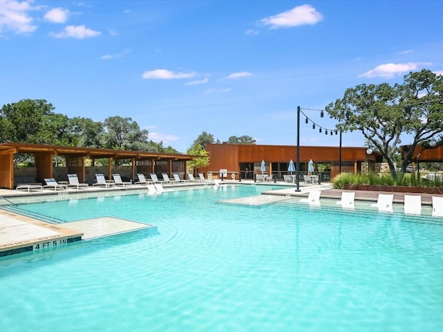 pool with a patio area and fence