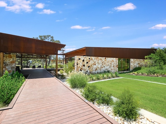 wooden deck featuring a yard