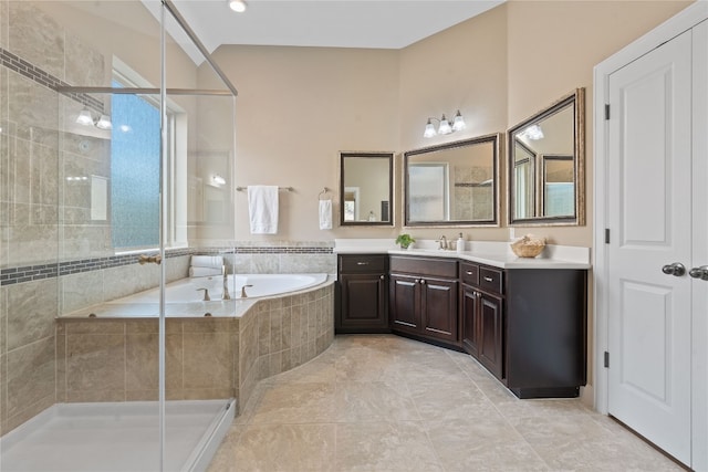 bathroom featuring tile patterned floors, vanity, and shower with separate bathtub