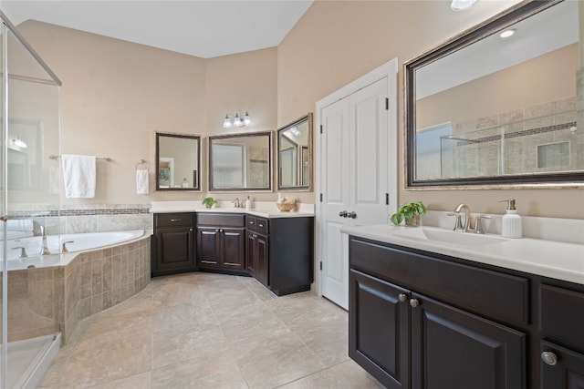 bathroom featuring separate shower and tub, dual bowl vanity, and tile patterned flooring