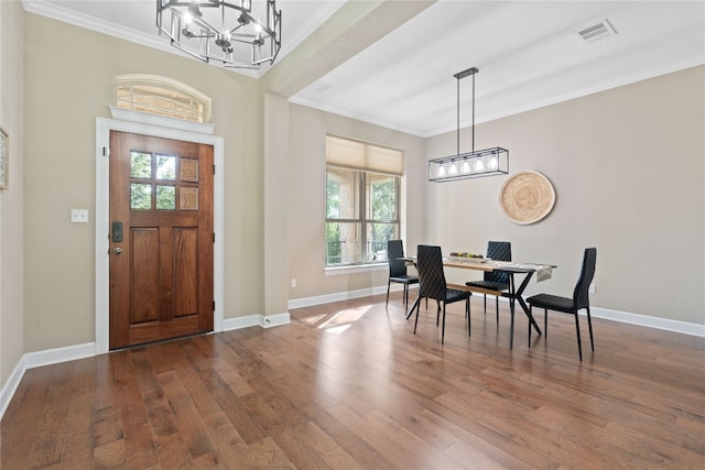 foyer featuring plenty of natural light, a notable chandelier, and hardwood / wood-style flooring