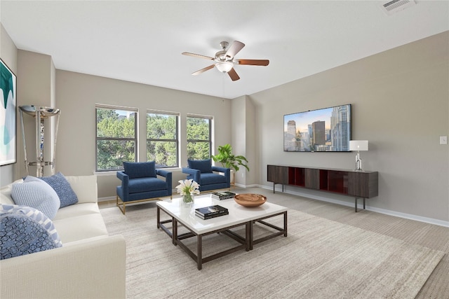 carpeted living room featuring ceiling fan