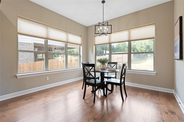 dining room with wood-type flooring and a notable chandelier