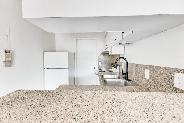 2808 Whitis Ave Unit C102, Austin, TX 78705 - kitchen with freestanding refrigerator, a sink, tasteful backsplash, and white cabinets