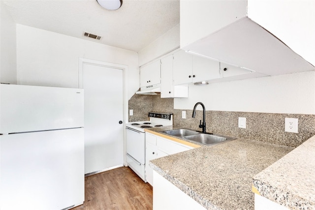 kitchen featuring tasteful backsplash, white appliances, light hardwood / wood-style floors, white cabinets, and sink