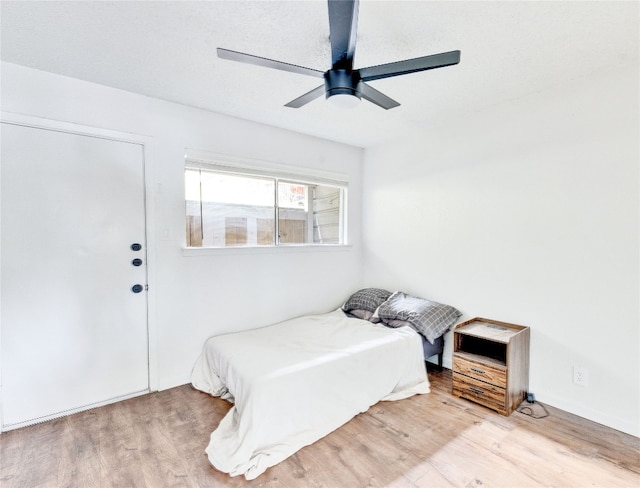 bedroom with ceiling fan and hardwood / wood-style flooring