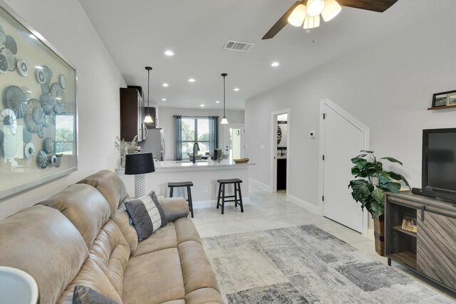 living room with ceiling fan and light tile patterned floors