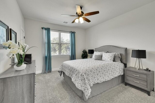 bedroom with ceiling fan and light colored carpet