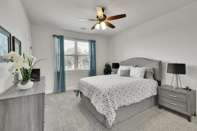 bedroom featuring a ceiling fan, light colored carpet, visible vents, and baseboards