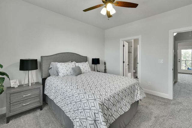 bedroom featuring baseboards, ensuite bath, a ceiling fan, and light colored carpet