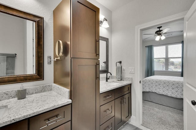 bathroom featuring ceiling fan and dual vanity