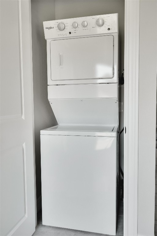 laundry area with stacked washer and dryer