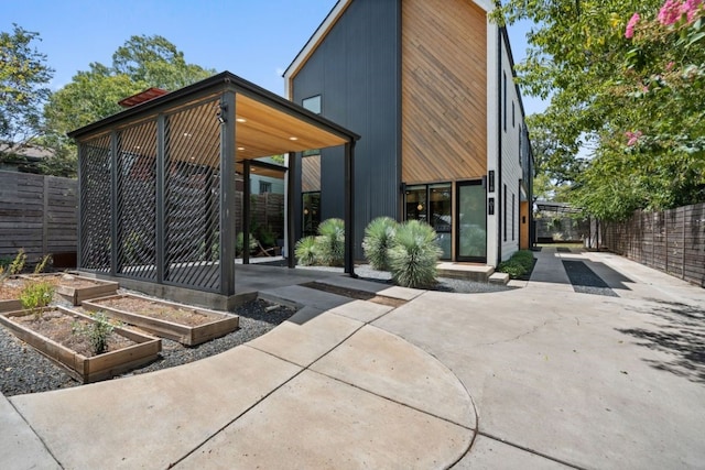 2118 Glendale Pl Unit 1, Austin, TX 78704 - back of property with a garden, a patio, and a fenced backyard