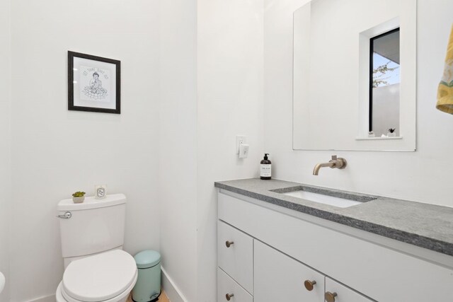 bathroom featuring vanity and toilet