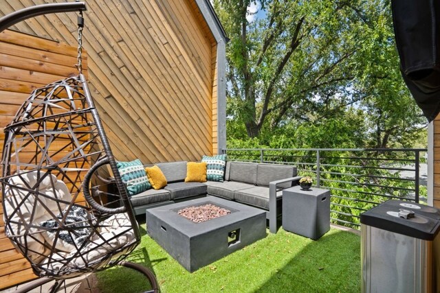 exterior space featuring an outdoor living space with a fire pit