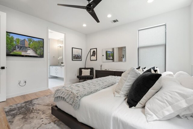 bedroom featuring ceiling fan, connected bathroom, and hardwood / wood-style flooring