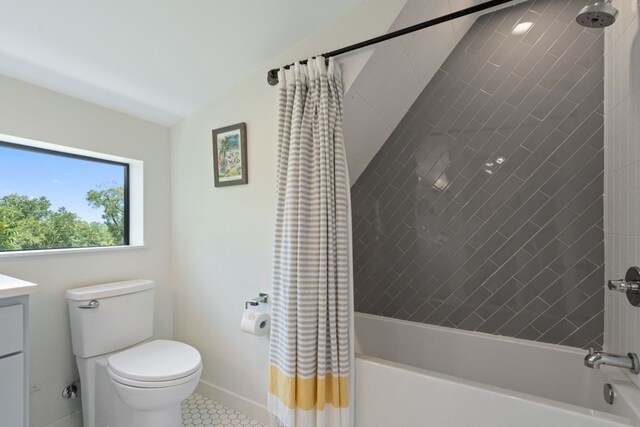 full bathroom with tile patterned floors, shower / tub combo with curtain, vanity, and toilet