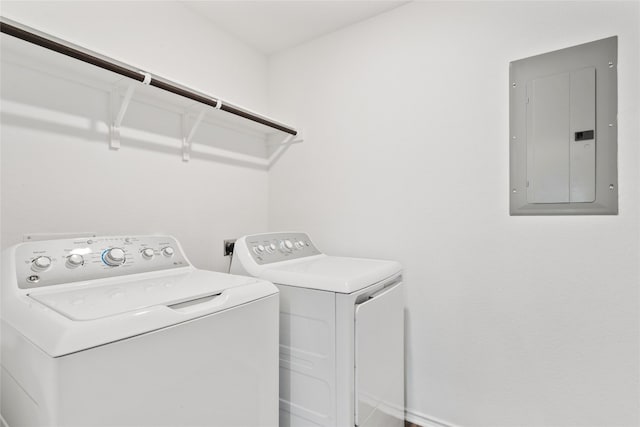 washroom with separate washer and dryer and electric panel