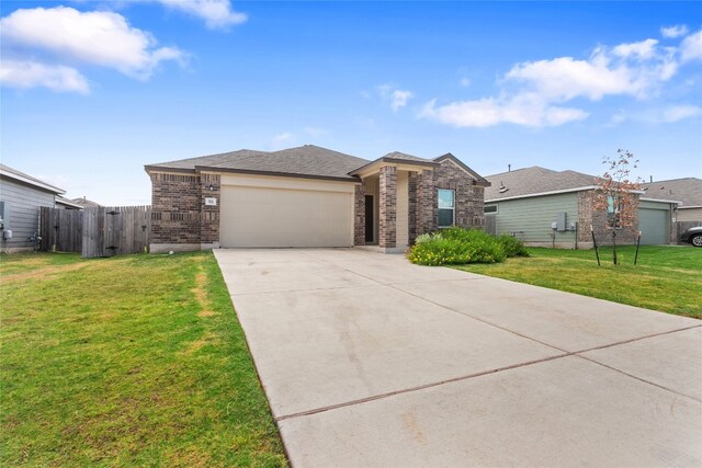 view of front of home featuring a front lawn and a garage