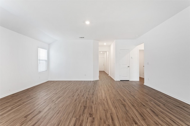 spare room with dark wood-type flooring