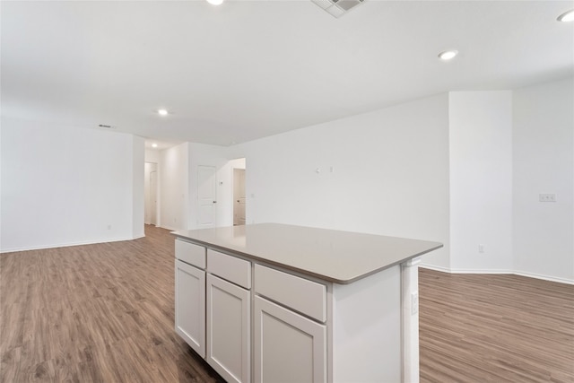 kitchen featuring a center island, white cabinets, and hardwood / wood-style floors